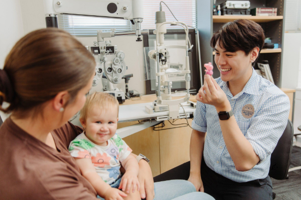 Parent discussing a child's eye examination with an optometrist near Five Dock